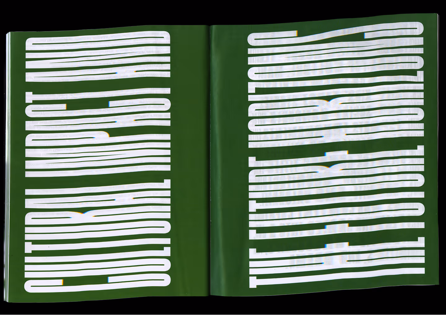 Open book with green pages and large white text reading 'Colour is more than just colour' spread across two pages.