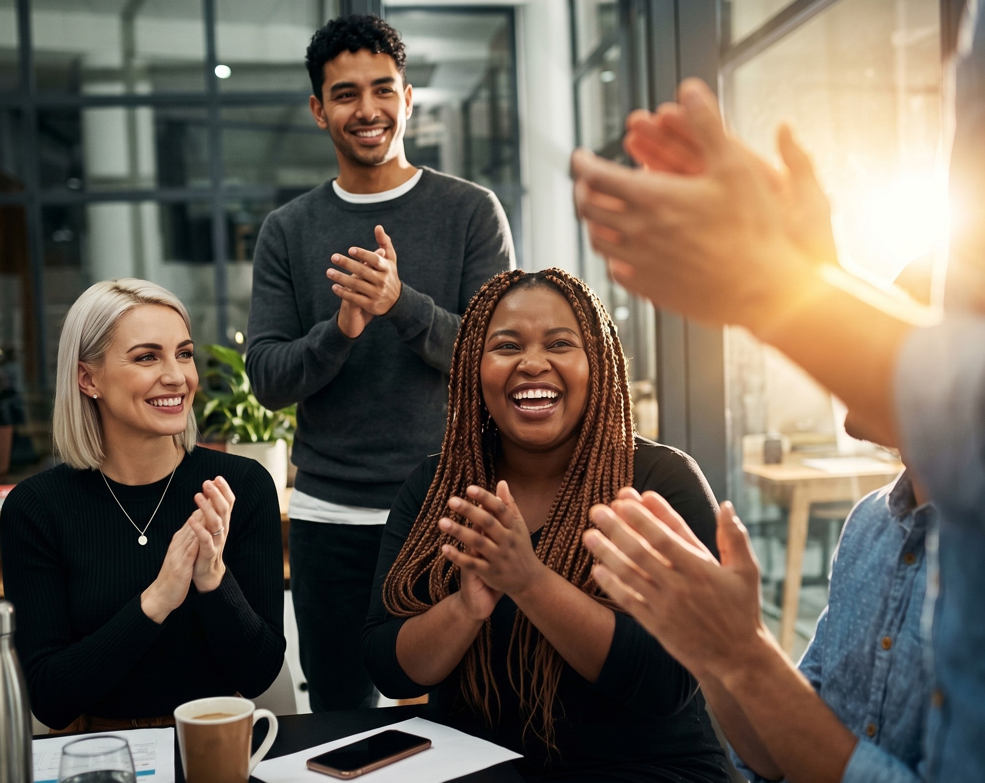 Diverse team celebrating together in a meeting