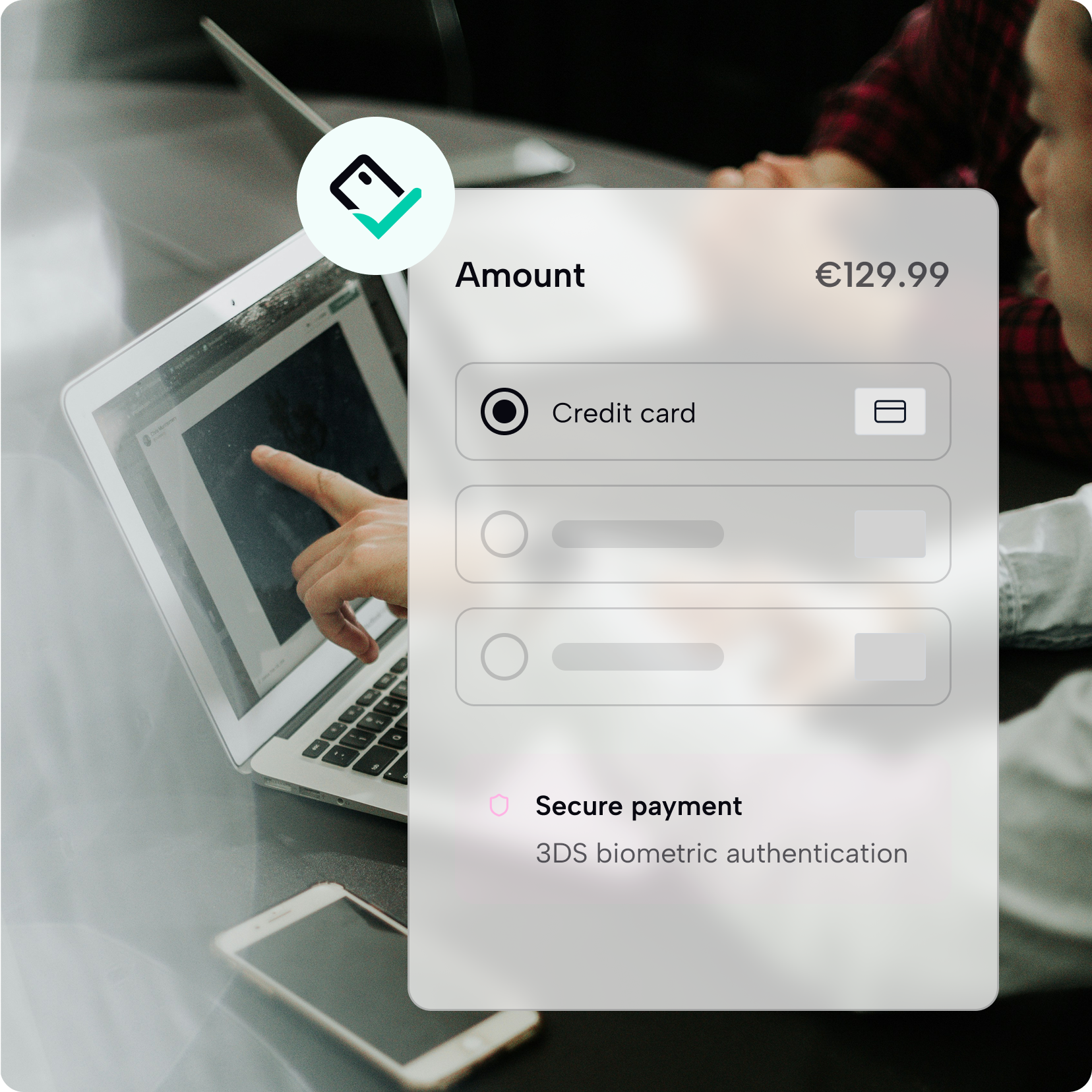 Person using a laptop with a payment interface showing a €129.99 credit card payment and secure 3DS biometric authentication.