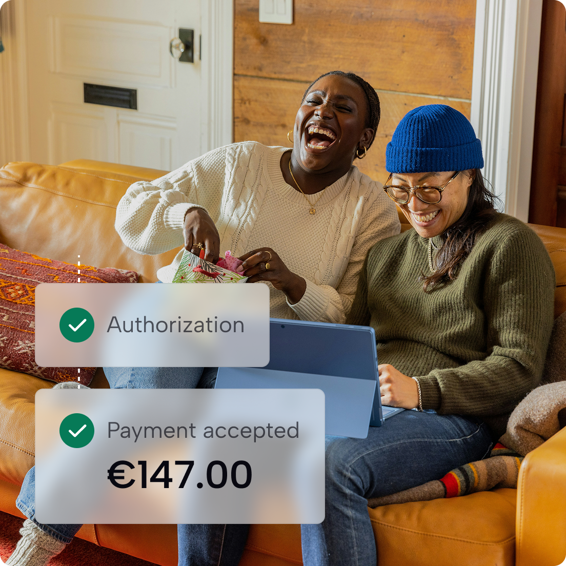 Two smiling people using a laptop, with confirmations of authorisation and an accepted €147 payment.