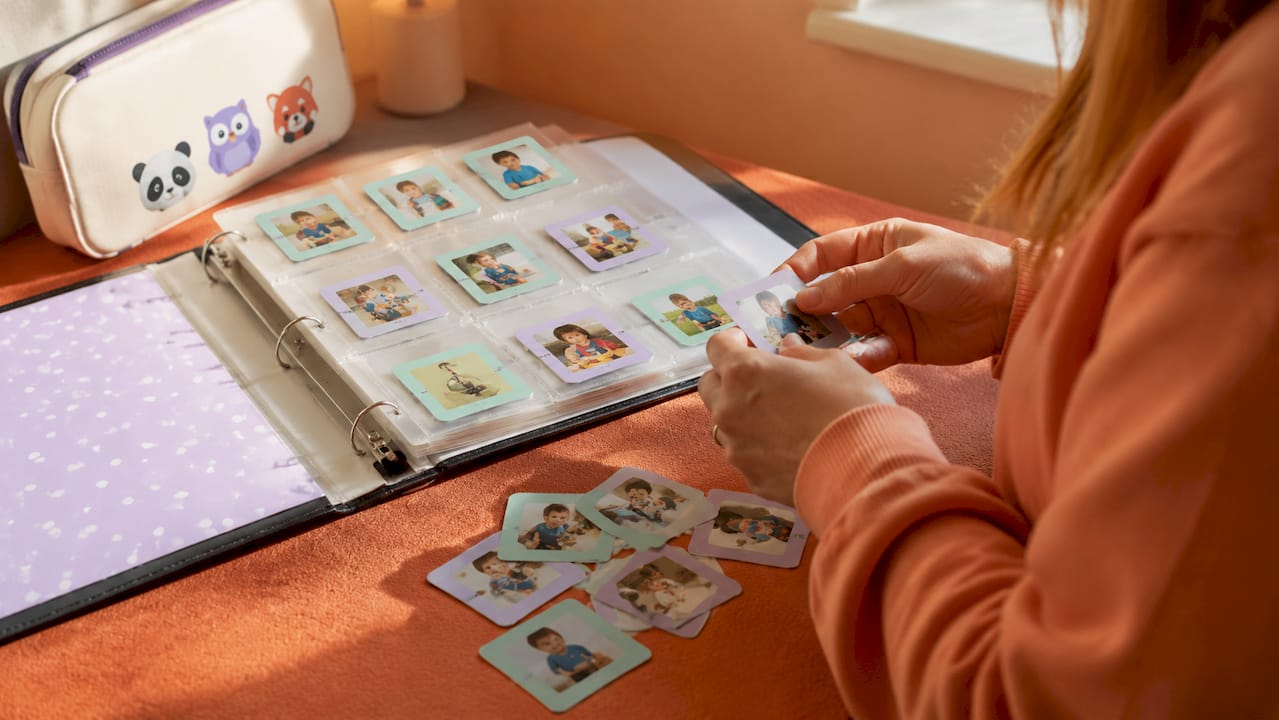 Close-up of PECS picture communication booklet and cards