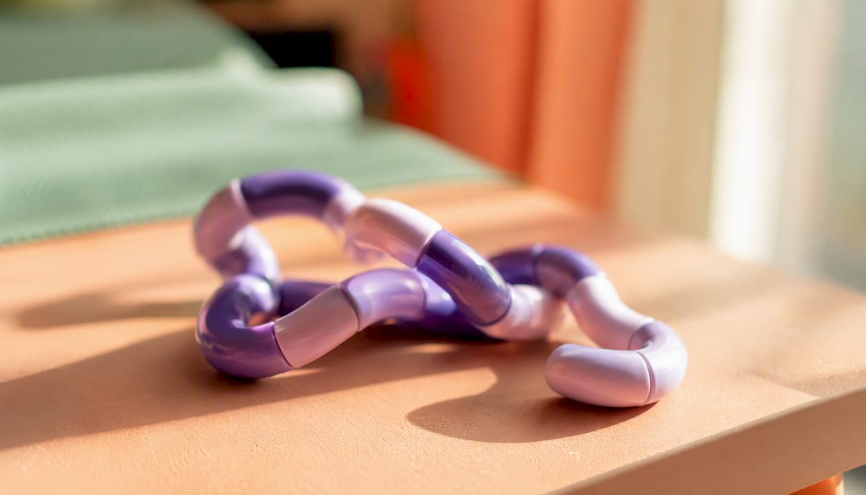 Partially twisted Tangle fidget toy on table