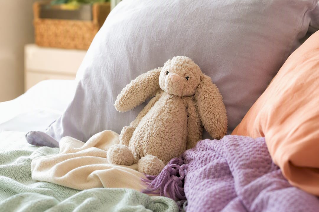 Toddler comfort object among cushions