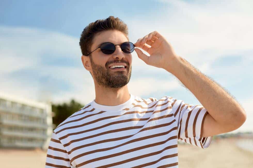 man out in the beach with rays hitting face