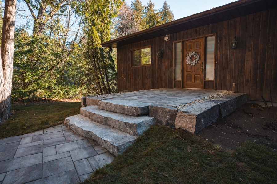 Natural stone steps and interlocking paver landing at a Kawartha Lakes cottage by TEG Contracting