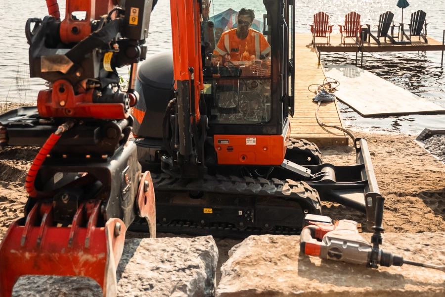 Mini excavator doing shoreline work at a Kawartha Lakes waterfront property by TEG Contracting
