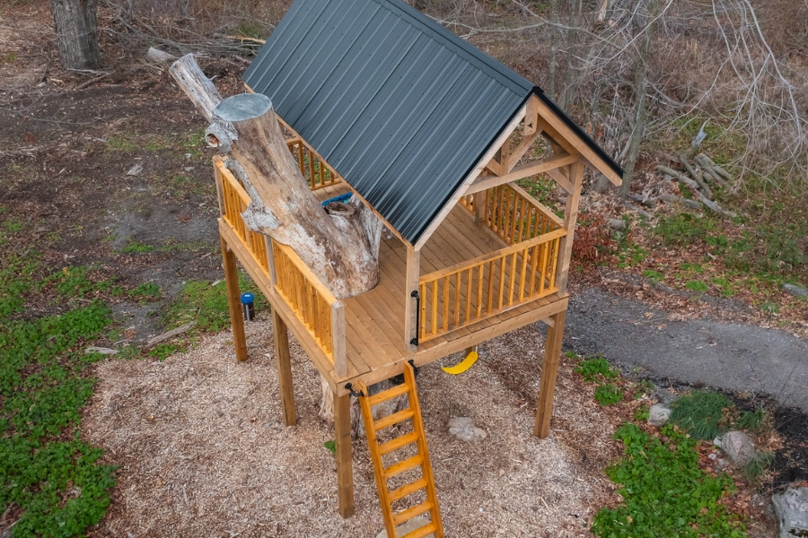 Aerial view of a custom tree house with metal roof in Kawartha Lakes by TEG Contracting