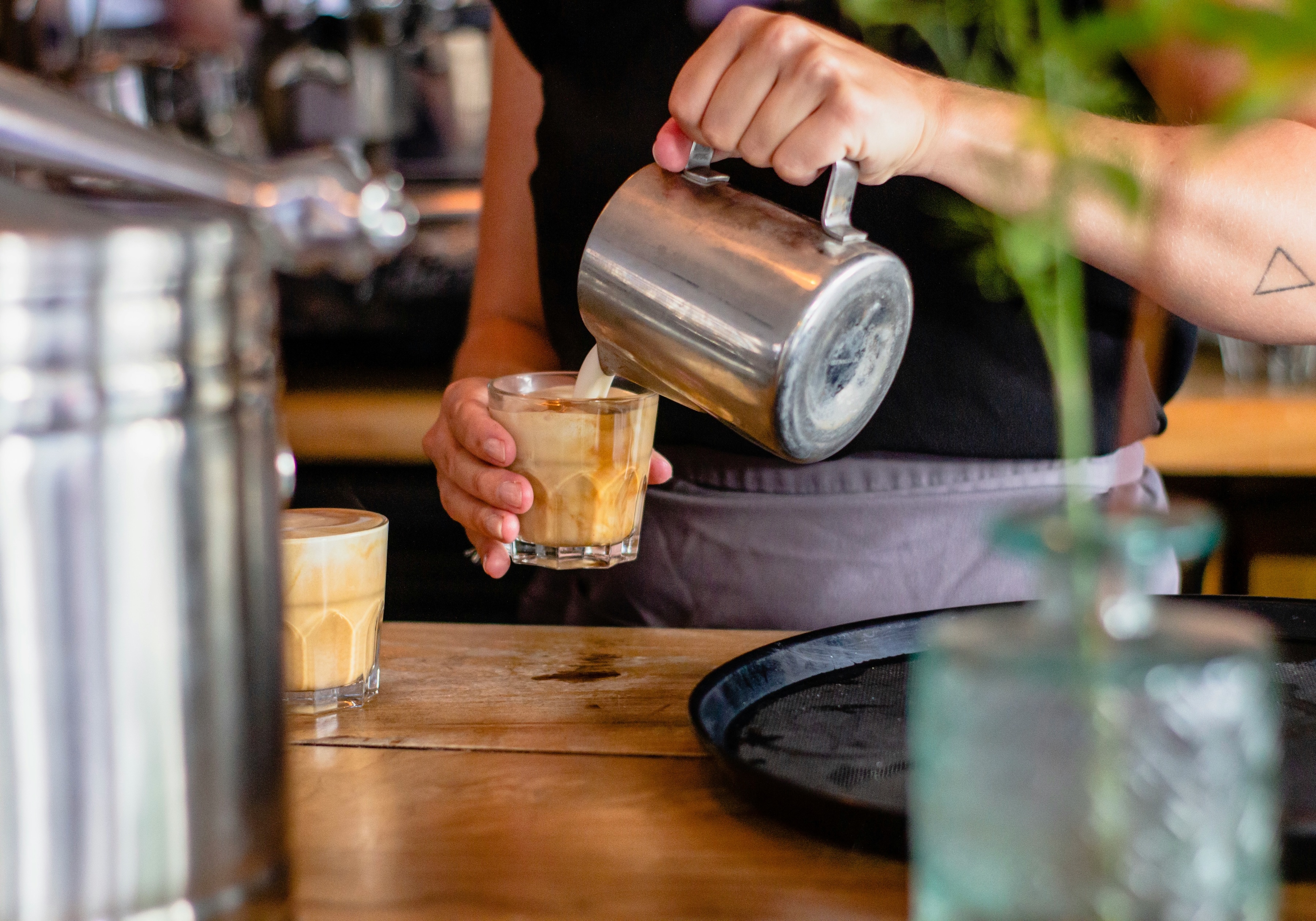 Pouring espresso into shot glass stock image