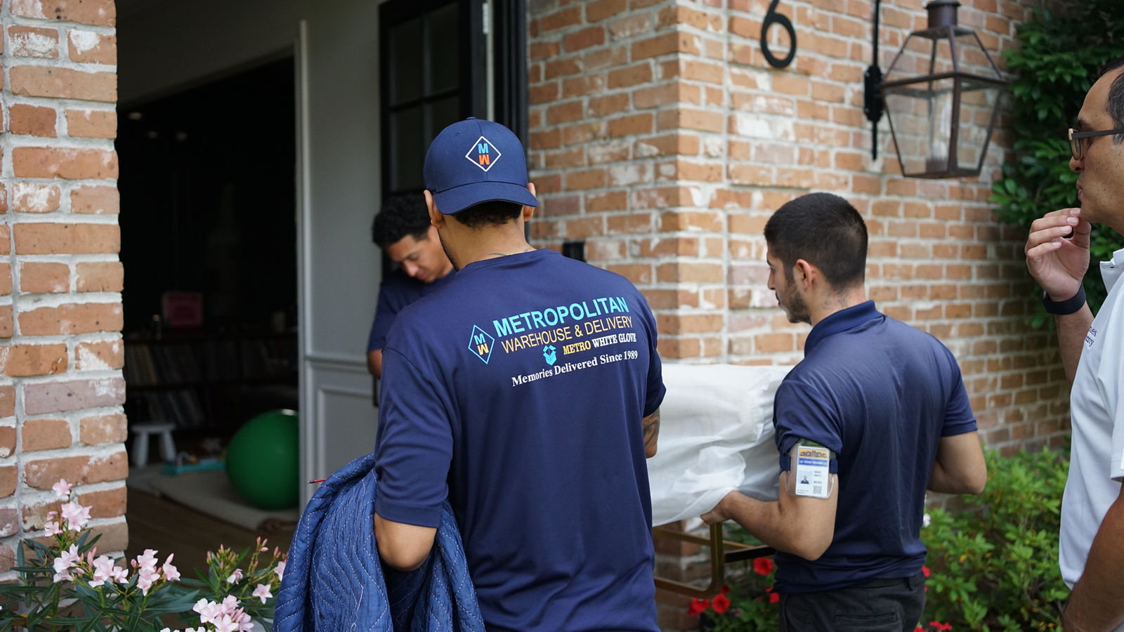Metropolitan white glove delivery team placing furniture in a customer's home