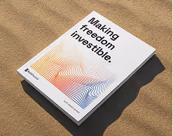 A Paradox report resting on sand, its cover reading "Making freedom investible." above a rainbow contour-line illustration.