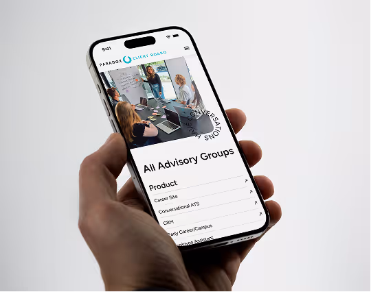 A hand holding an iPhone showing the Paradox Client Board app open to an "All Advisory Groups" list.