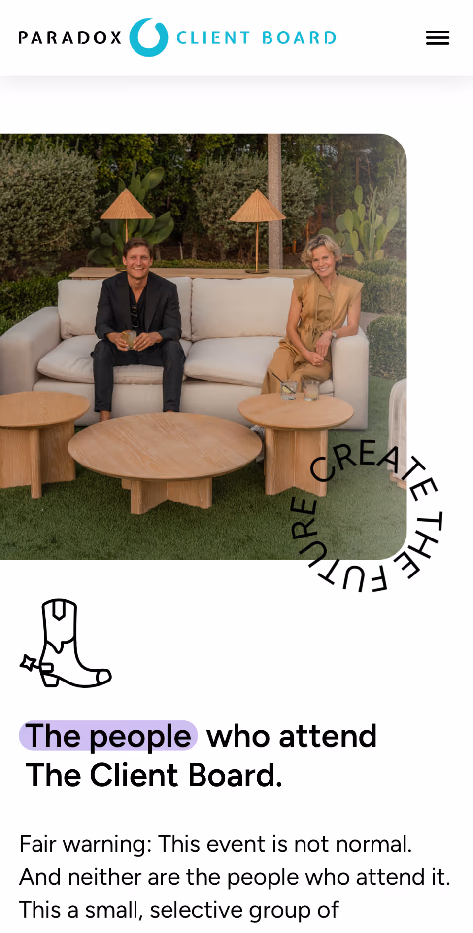 Two people sitting on a white sofa outdoors with wooden tables and lamps behind them.