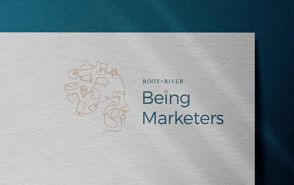 The Being Marketers logo printed on textured card above a dark teal band.