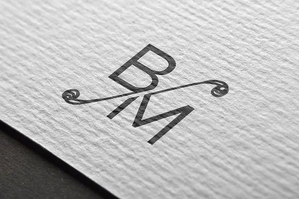 The Being Marketers BM monogram embossed on textured white paper.