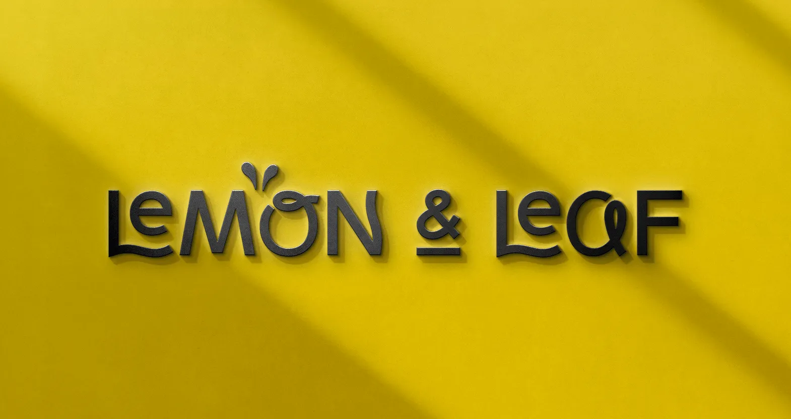 The Lemon & Leaf wordmark embossed on a yellow surface.