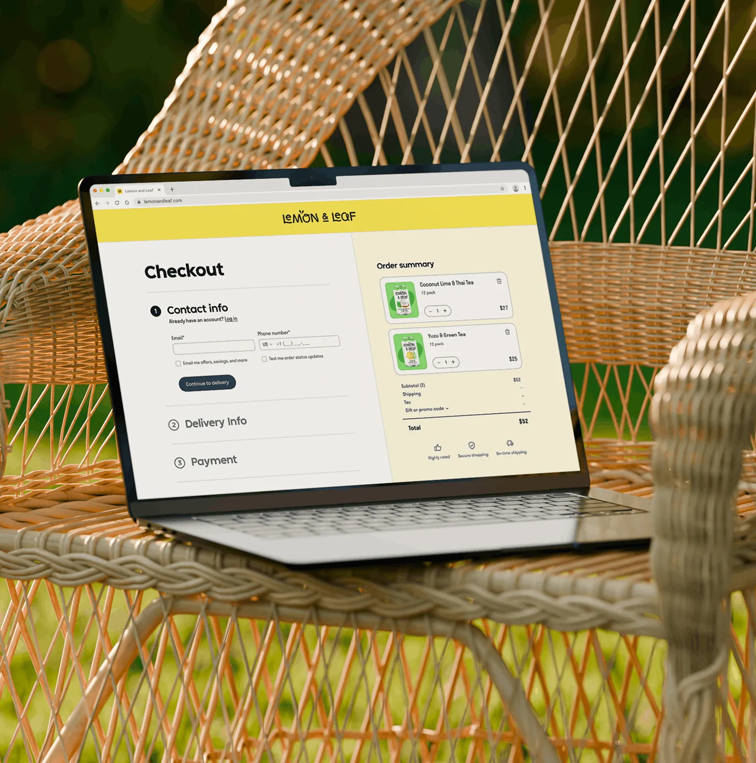 A laptop on a woven outdoor chair displaying the Lemon & Leaf checkout page.