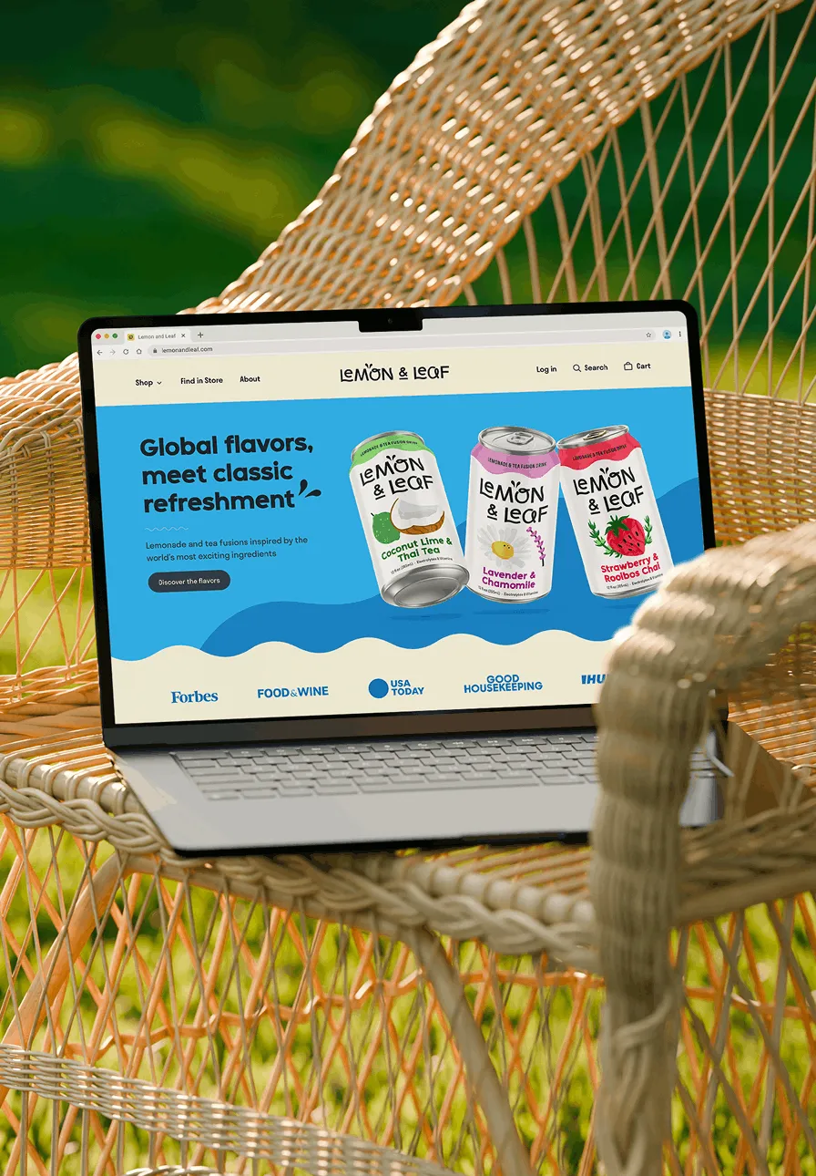 A laptop on a woven outdoor chair displaying the Lemon & Leaf homepage.
