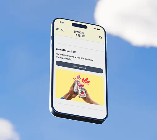 A phone against a blue sky showing a Lemon & Leaf refer-a-friend offer.