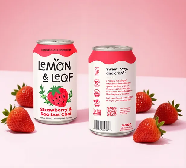 A Lemon & Leaf Strawberry & Rooibos Chai can beside fresh strawberries on a pink background.