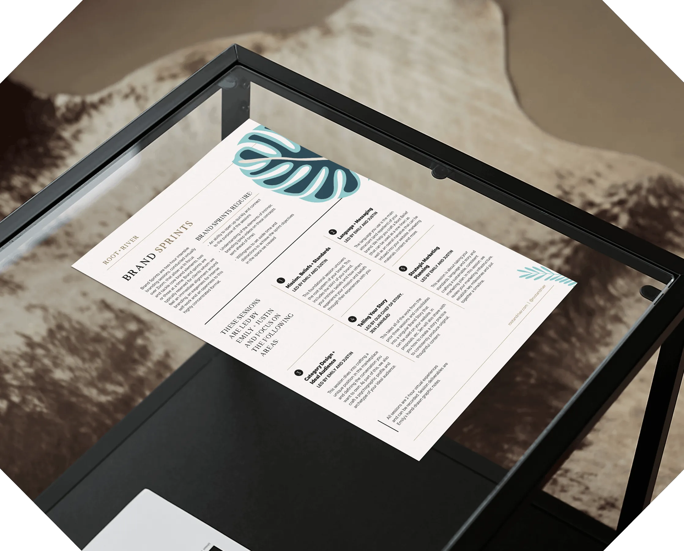 A printed Root + River one-sheet on a glass table, headed with a leaf illustration.