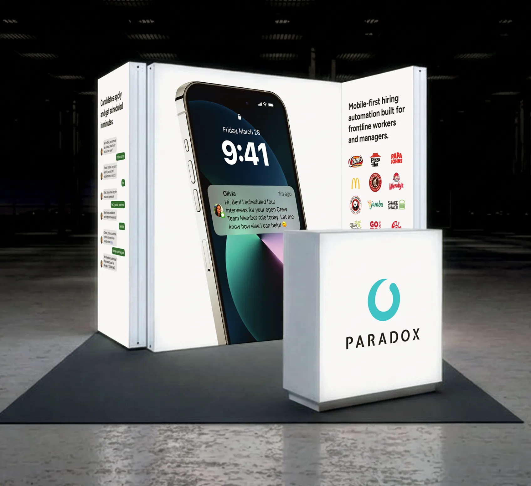 A Paradox trade show booth with a large phone-shaped display showing a chat interface.