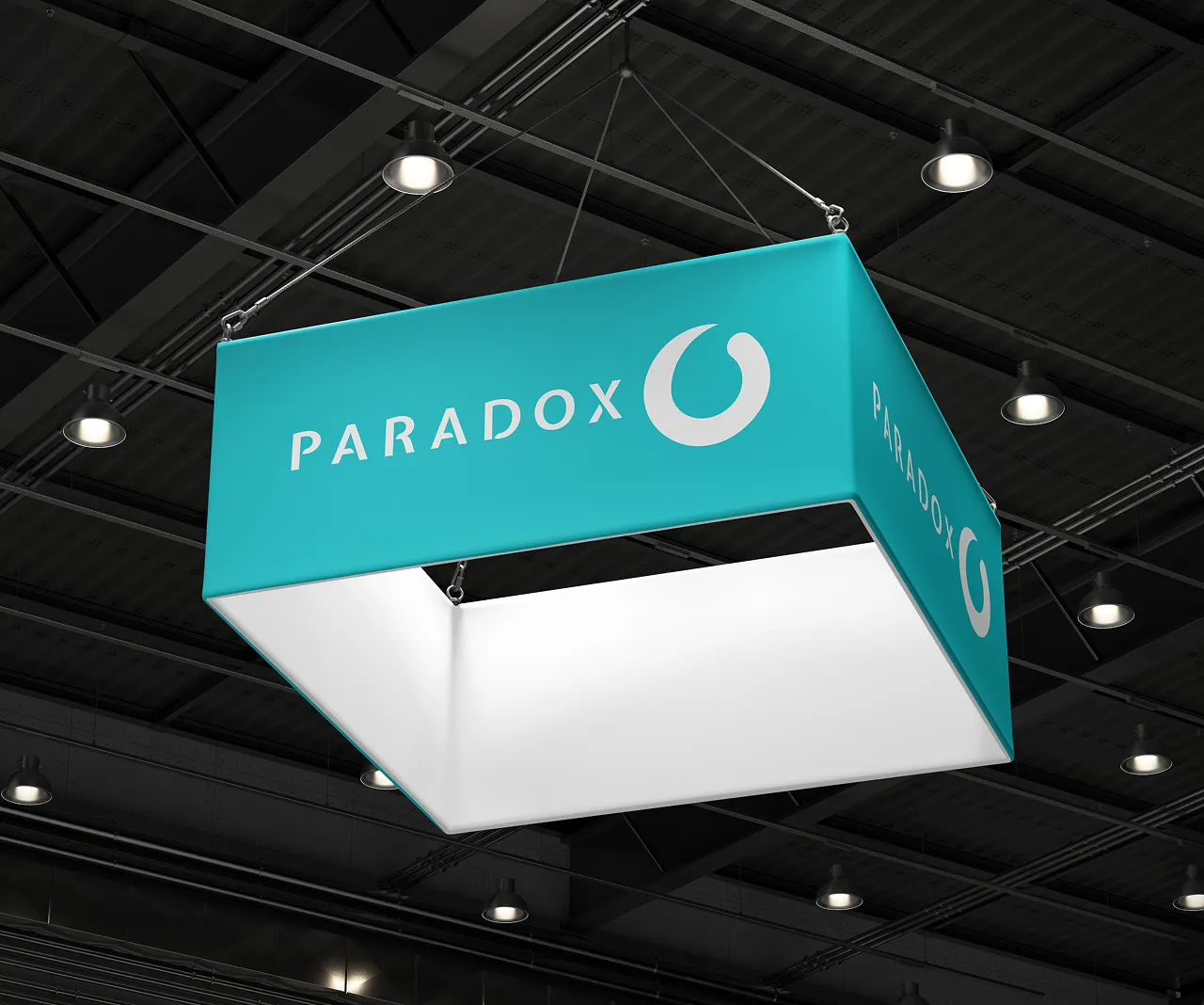 A suspended teal Paradox banner with the brand logo hanging above a conference hall.