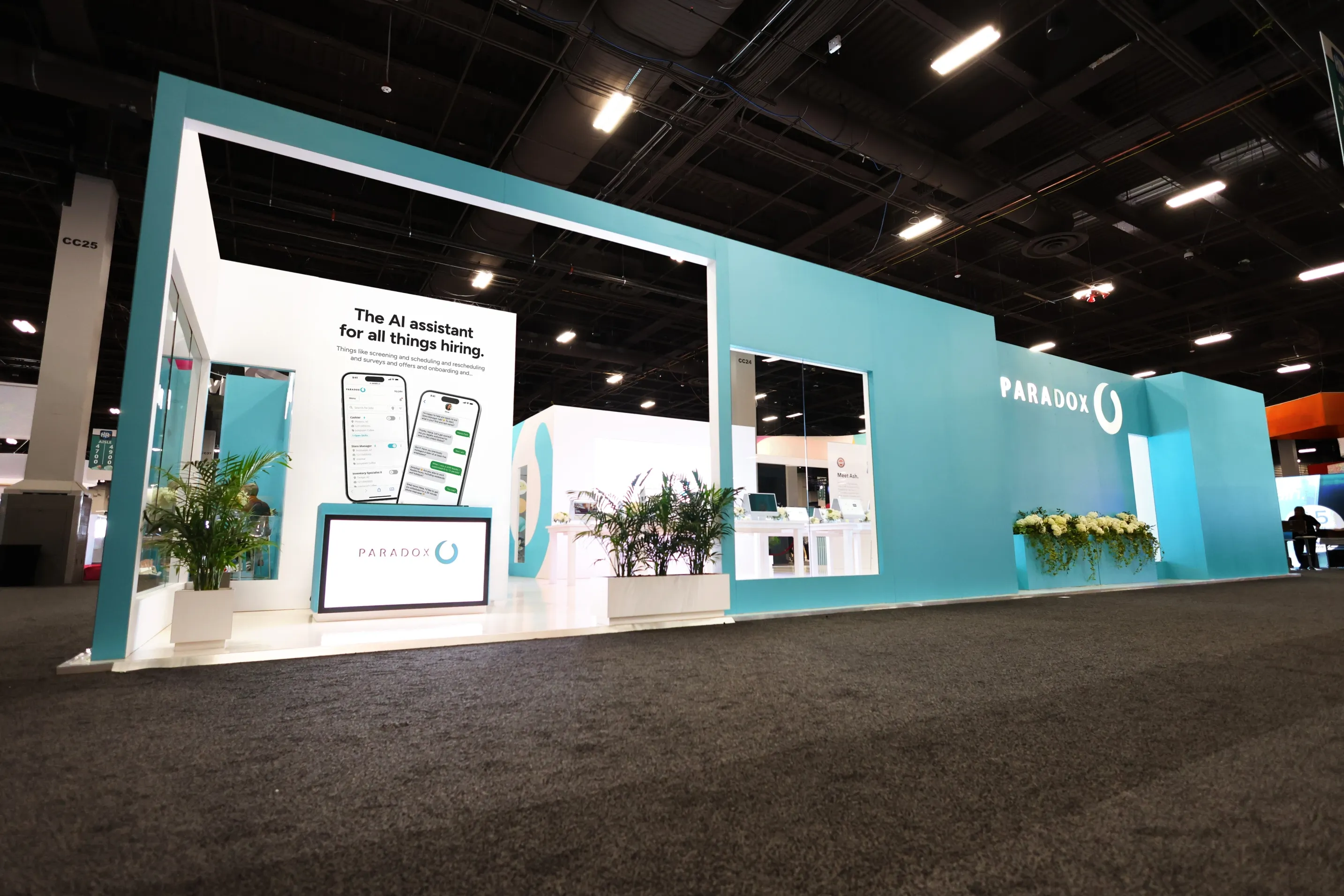 A wide view of a large Paradox exhibition stand on a busy conference floor.
