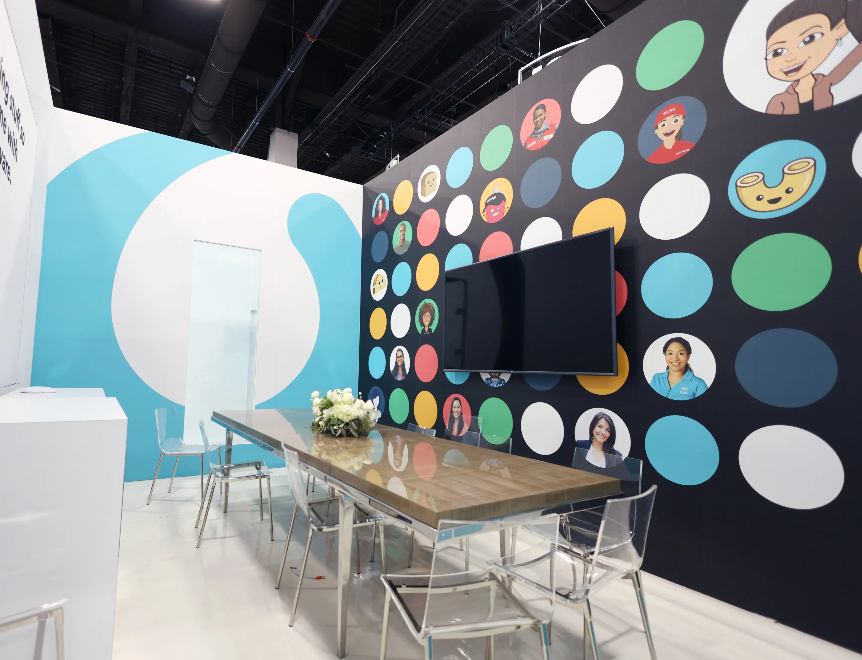 A Paradox event space with a patterned wall of colourful circles behind a long table.