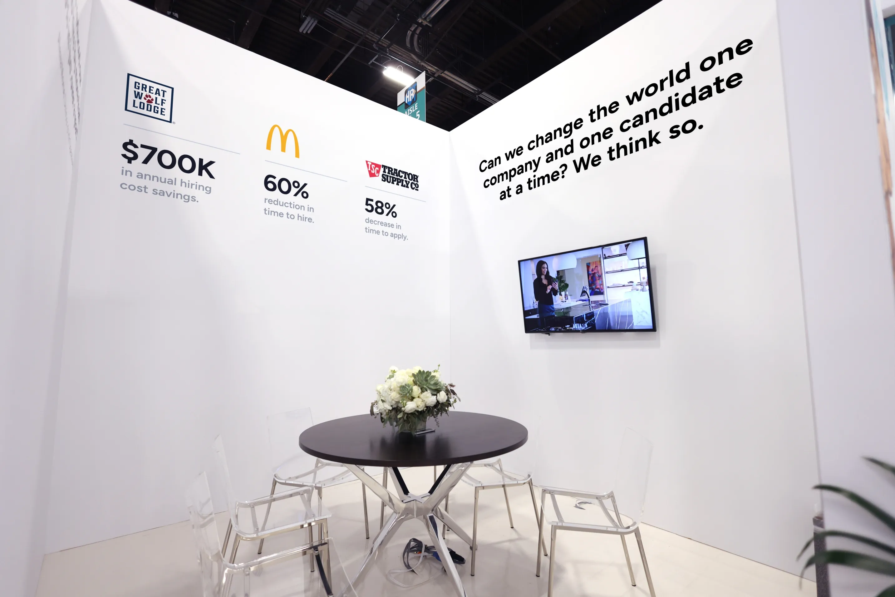 A Paradox booth wall showing client logos and results statistics including $700K and 60 percent.