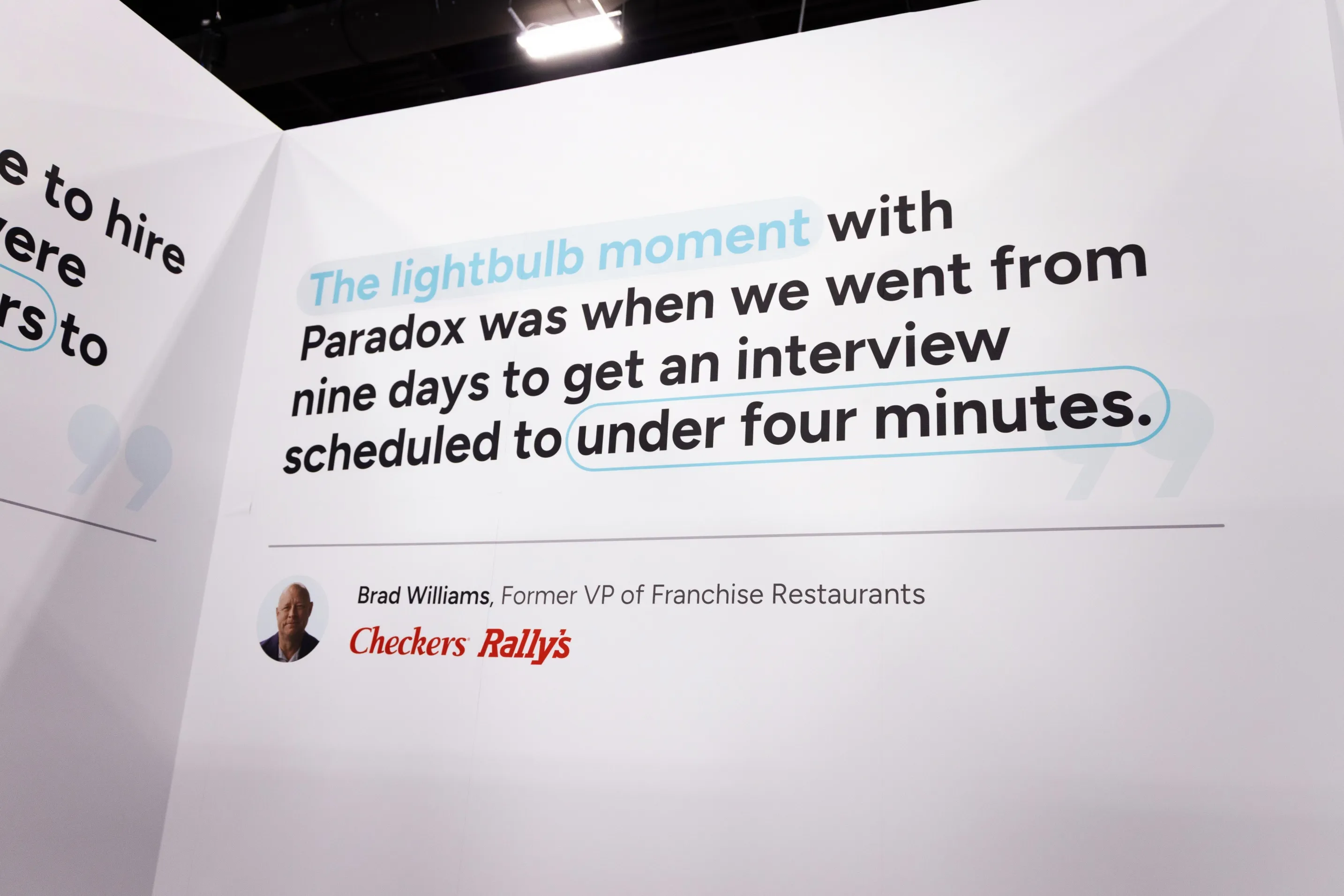 A Paradox booth quotation wall on cutting interview scheduling from nine days to four minutes.