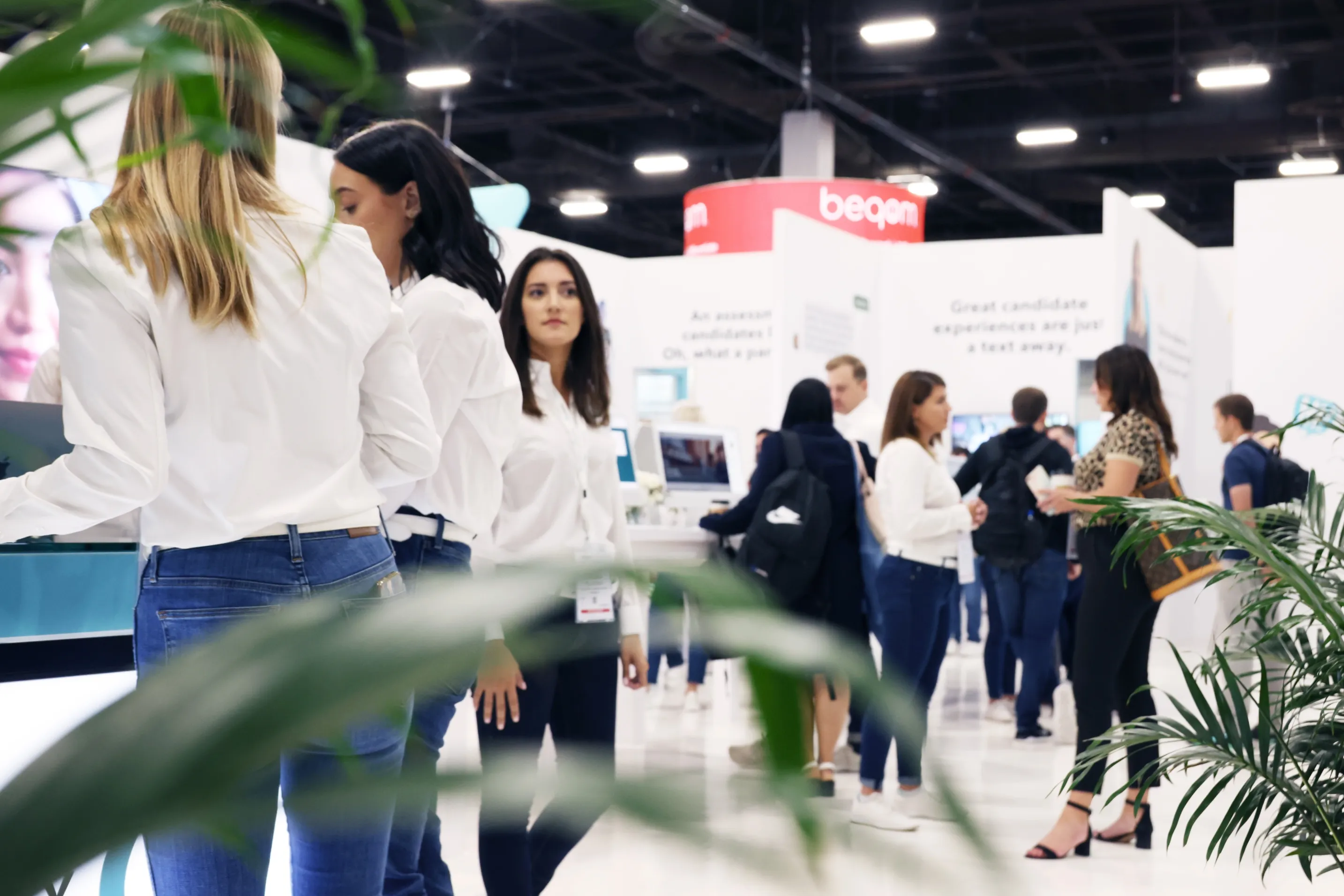 Attendees mingling on a busy conference floor beside the Paradox stand.