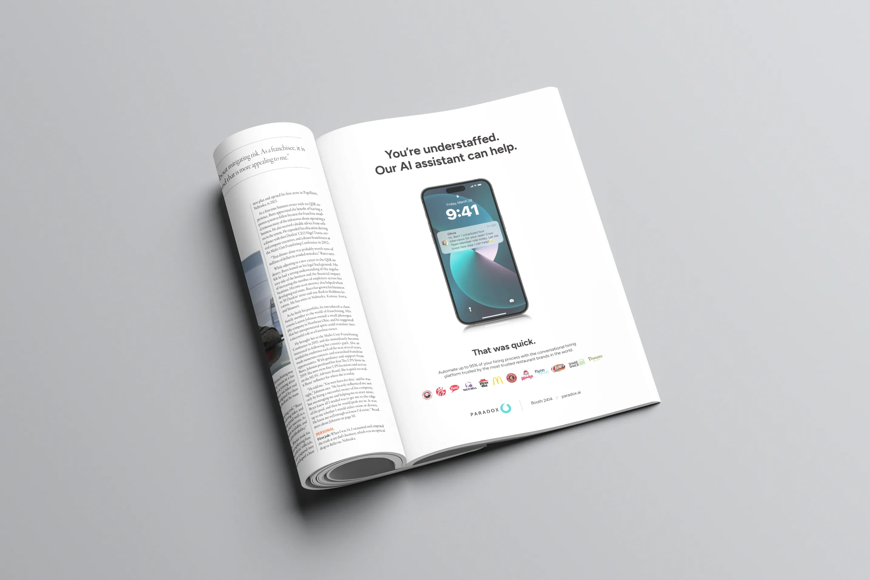 A rolled magazine on a grey background, open at a Paradox advertisement.