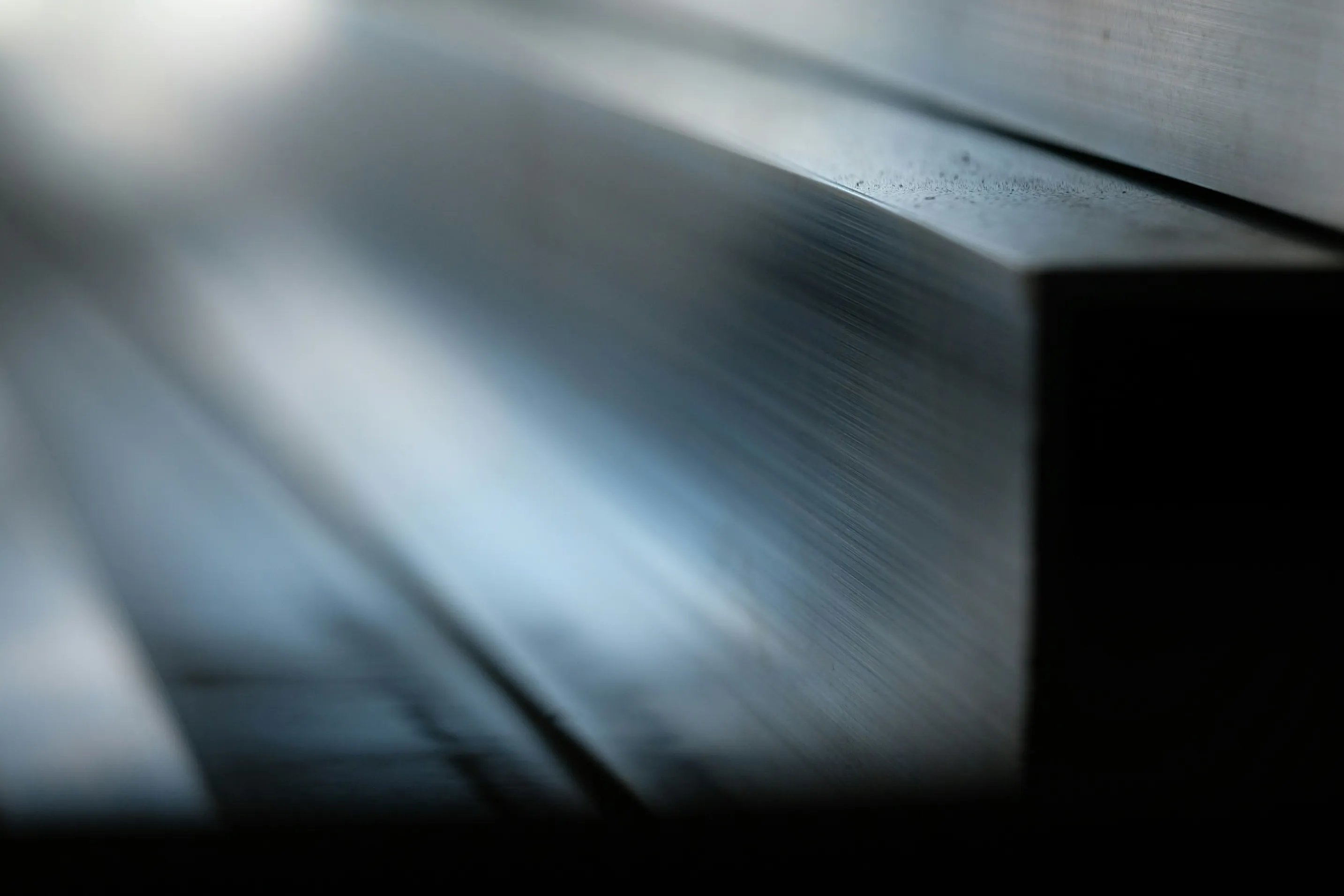 A softly blurred abstract background in muted blue and grey tones.