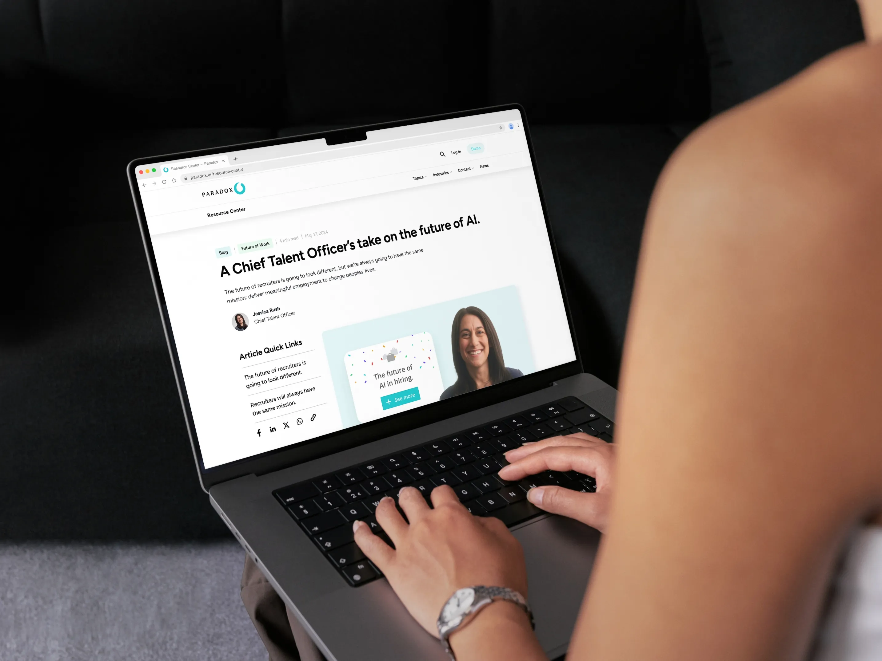 A person typing on a laptop that displays a Paradox talent acquisition resource page.