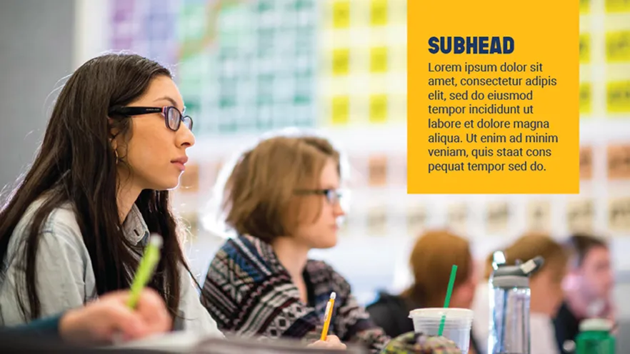 Students with glasses attentively taking notes in a classroom setting with a yellow text box.