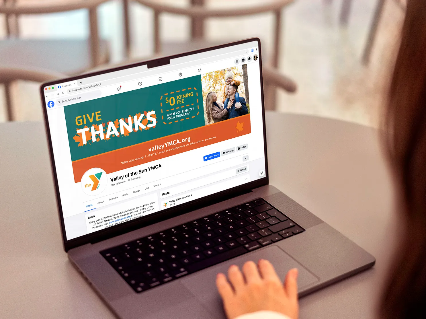 A laptop displaying the YMCA site with the "Give Thanks" campaign in place.