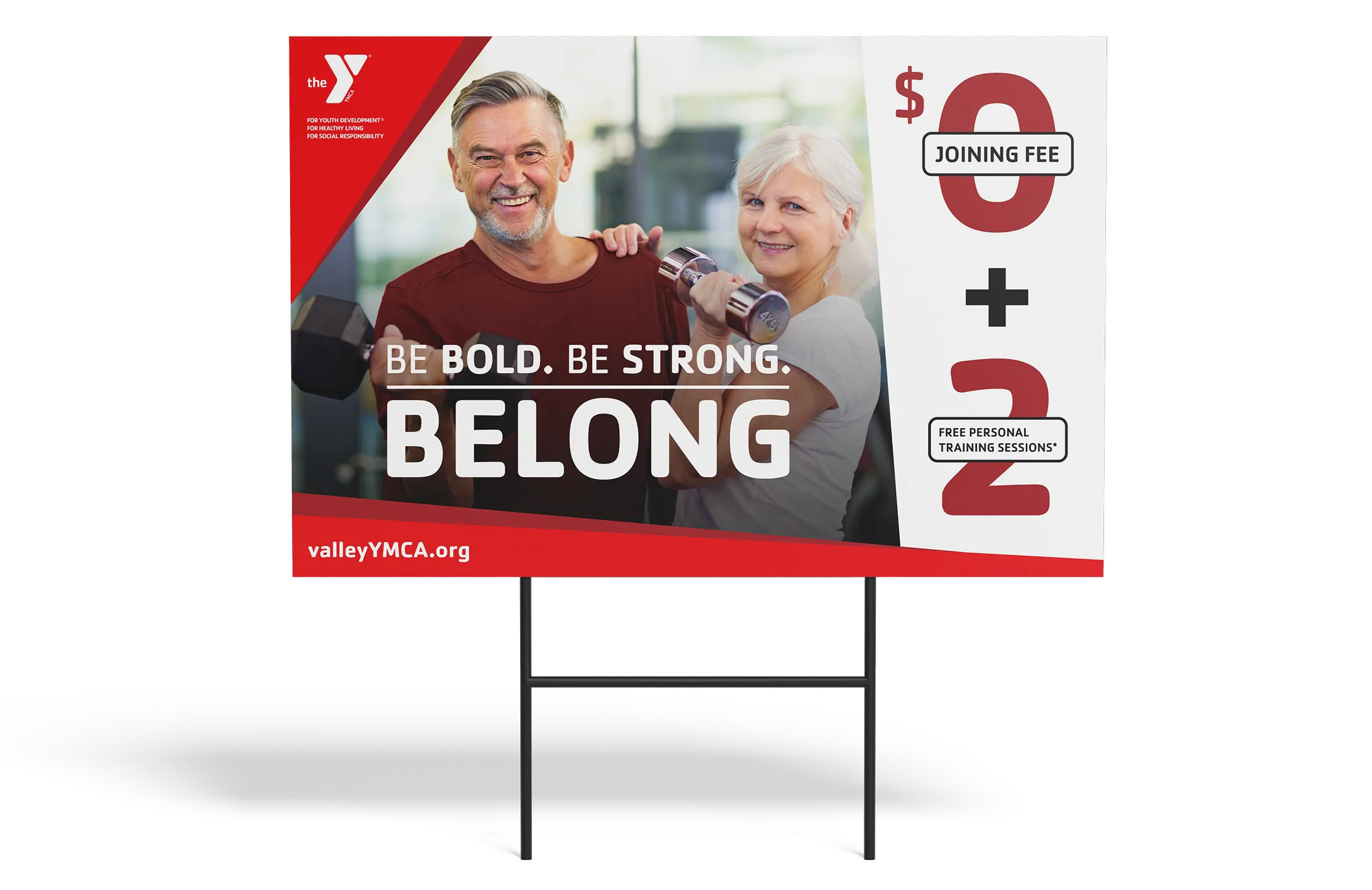 A YMCA lawn sign in red reading "Be Bold. Be Strong. Belong." with a $0 joining fee.
