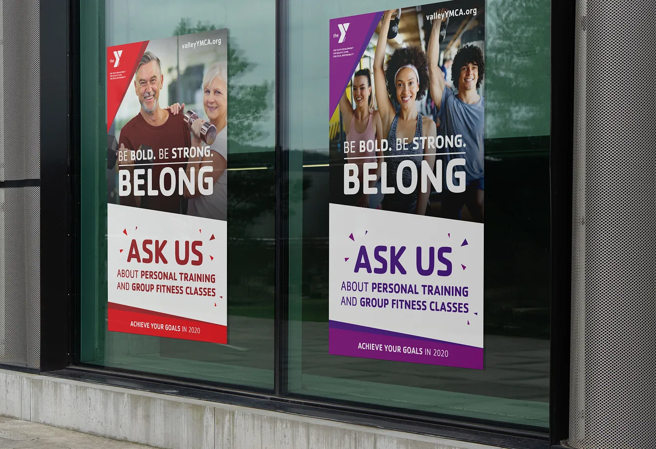 YMCA "Ask us" window posters in red and purple at a branch entrance.