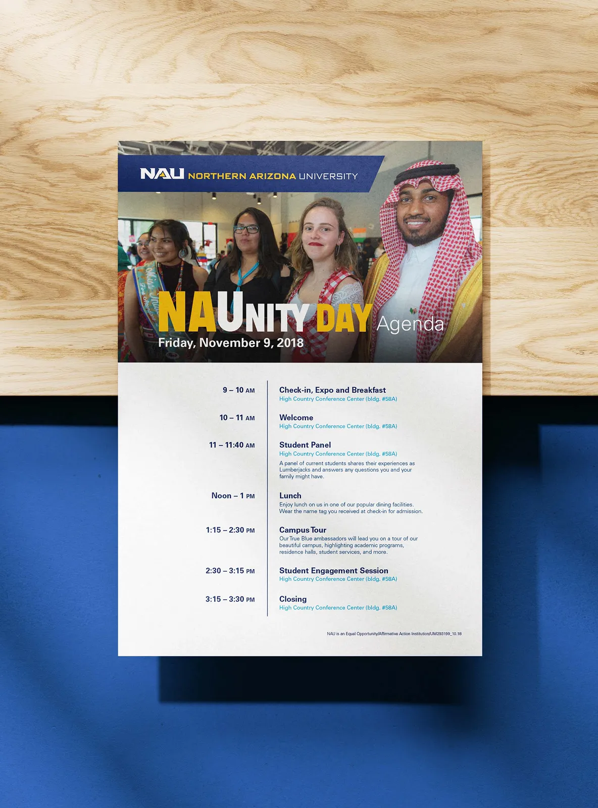 Northern Arizona University commencement booklet with graduate lifted by peers in cap and gown.