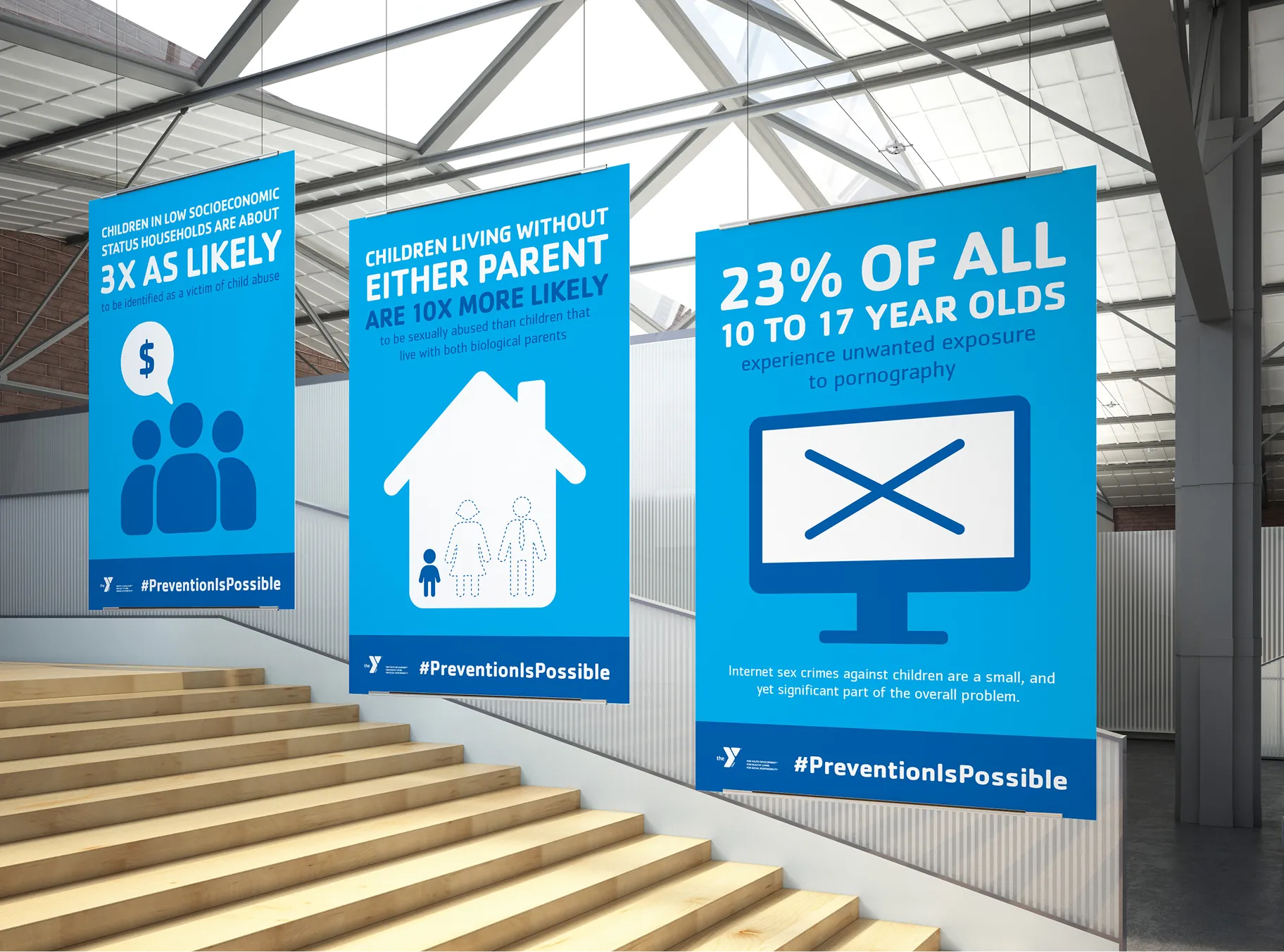 A row of blue YMCA awareness posters beside a staircase, each presenting a statistic.