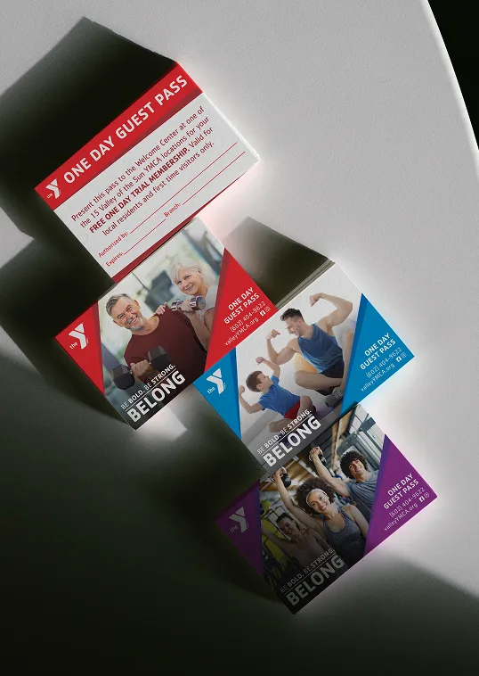 YMCA campaign cards in several colourways falling against a dark background.