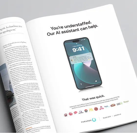 An open magazine spread with a Paradox advert reading "You're understaffed. Our AI assistant can help."