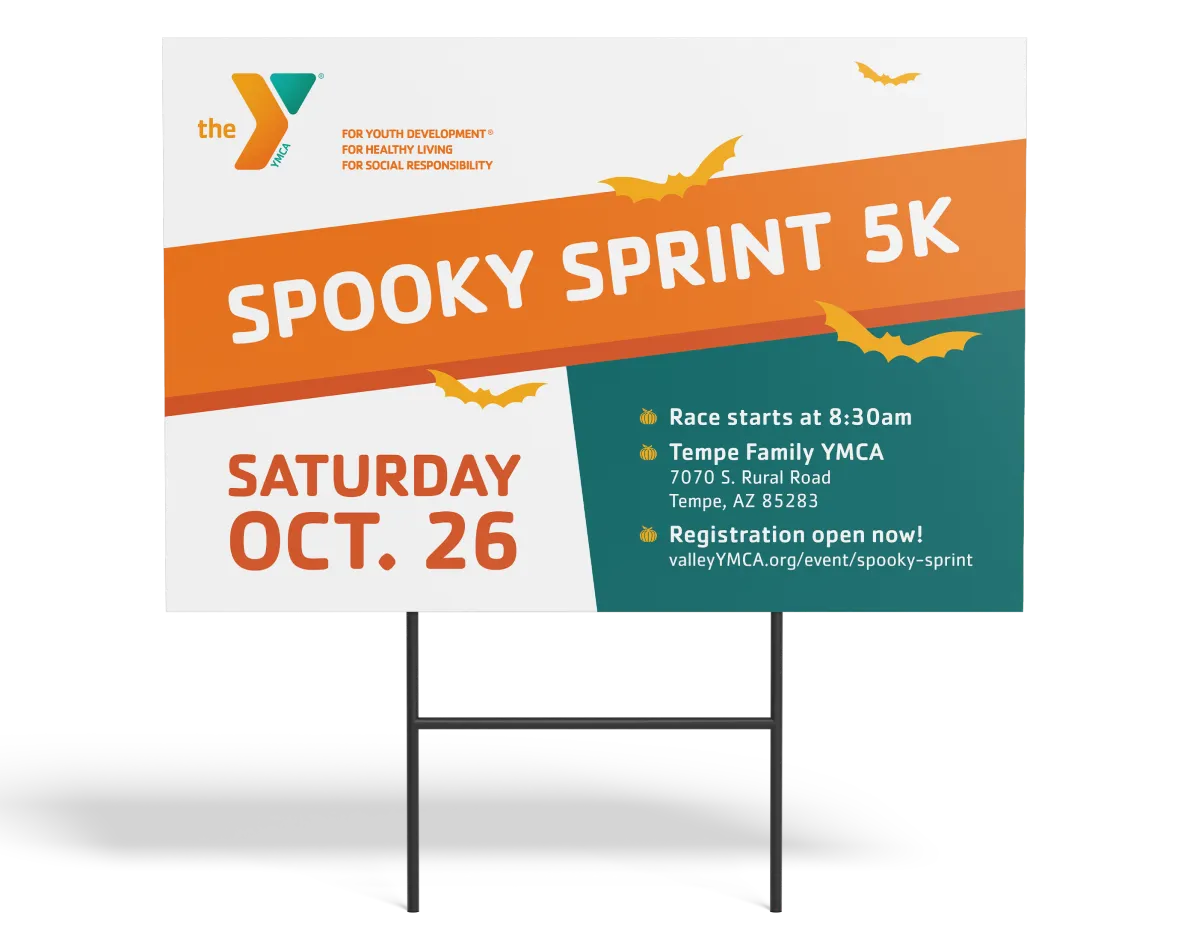 A YMCA "Spooky Sprint 5K" lawn sign giving the date and start details.