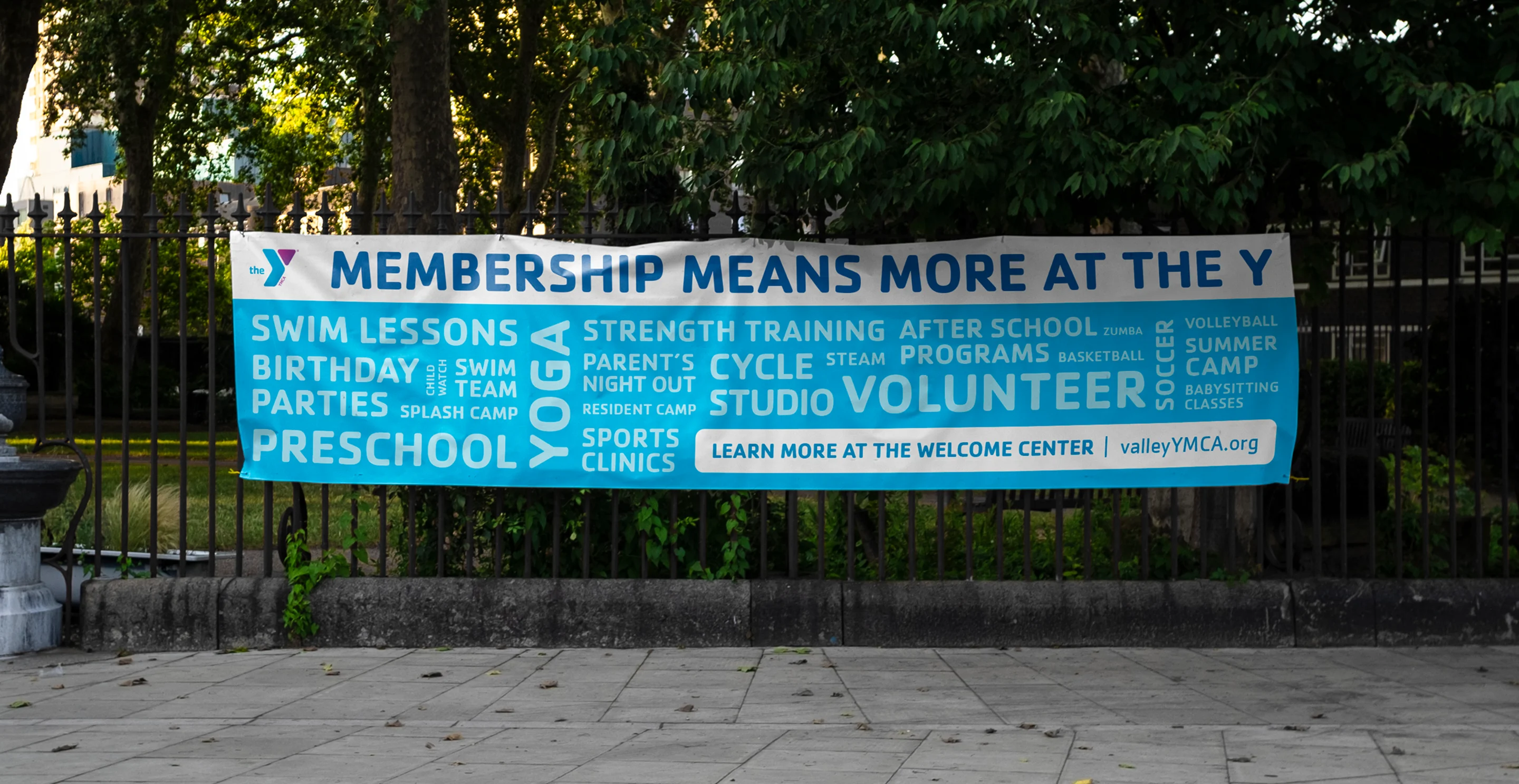 A YMCA banner reading "Membership means more at the Y", listing programmes and volunteering.