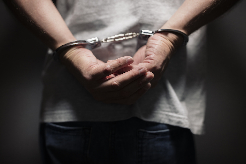 Suspect wearing handcuffs.