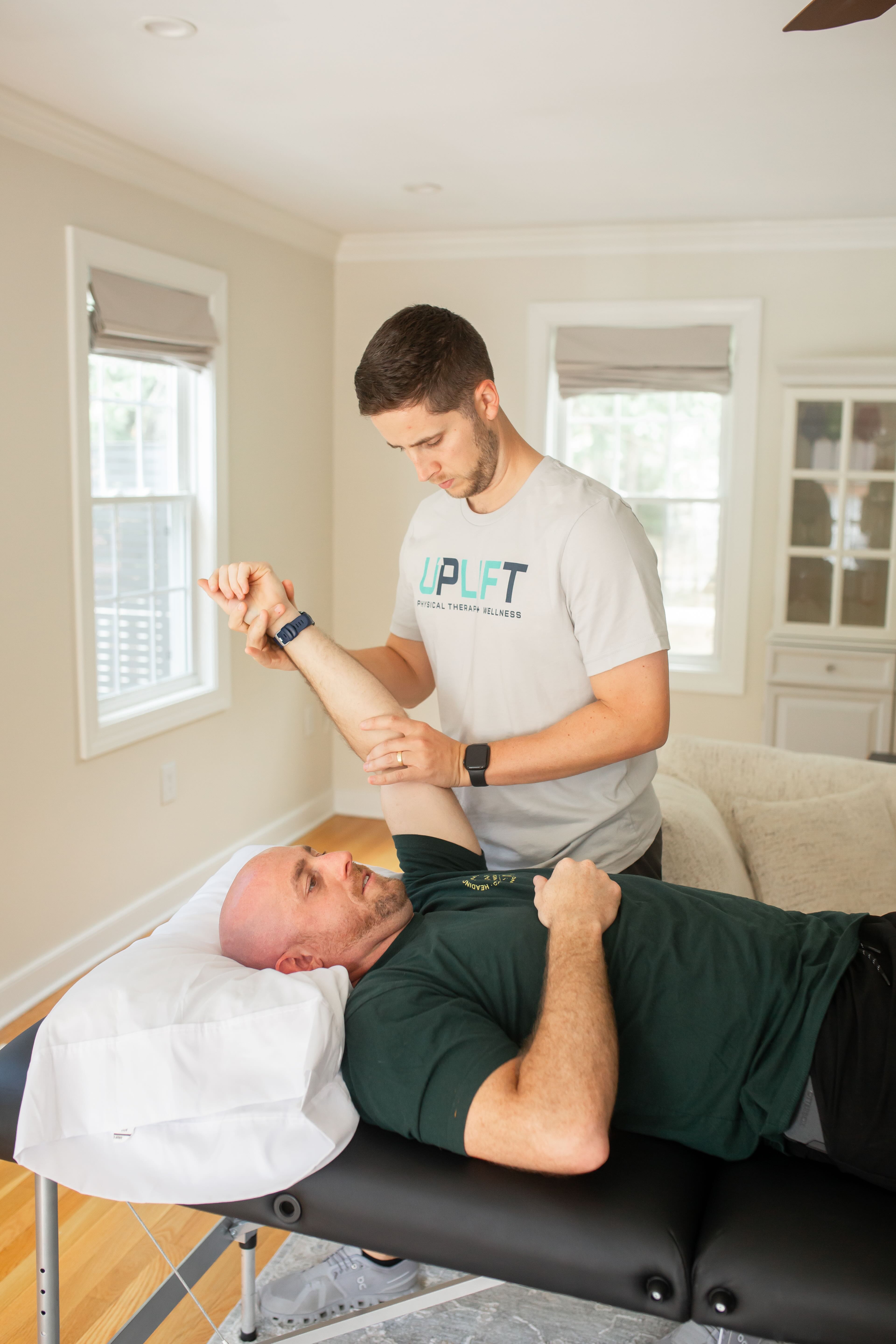 Patient receiving manual therapy for shoulder pain at a physical therapy clinic in Midlothian, VA