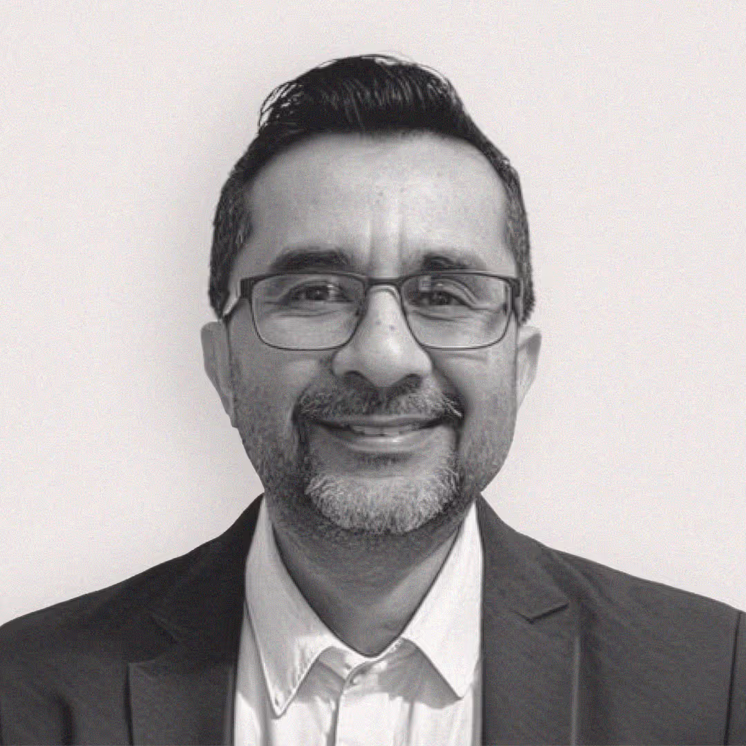 Headshot of Mo Fakhar, VP of CLM & AI Automation Services at axa·nexa, smiling with glasses, beard, and mustache wearing a suit jacket and collared shirt.