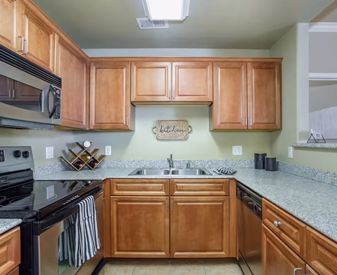 Kitchen with brown cabinets and stainless steel appliances