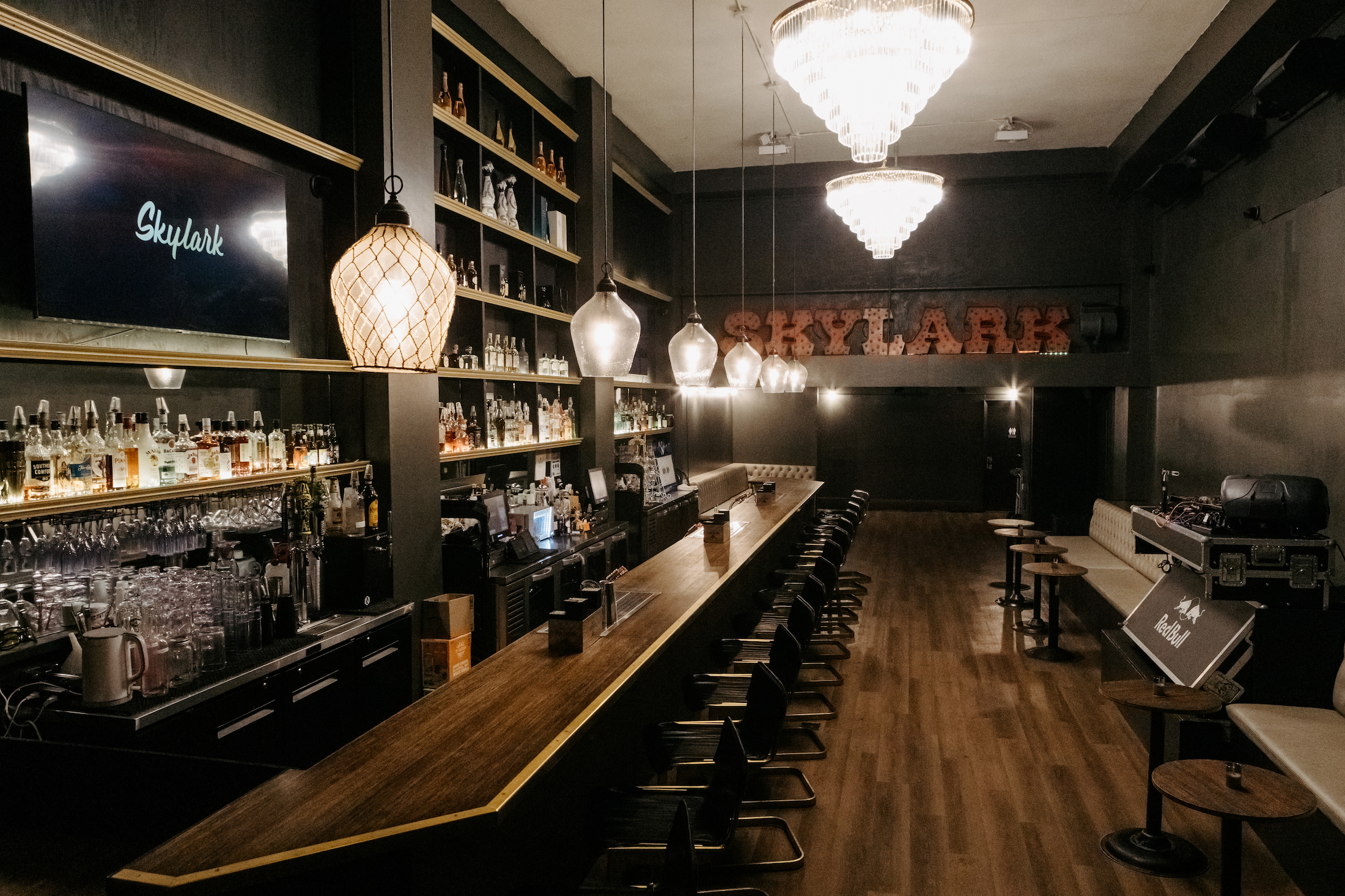 Full interior view of Skylark private event venue and bar in San Francisco's Mission District showing bar, lounge seating, and stage area