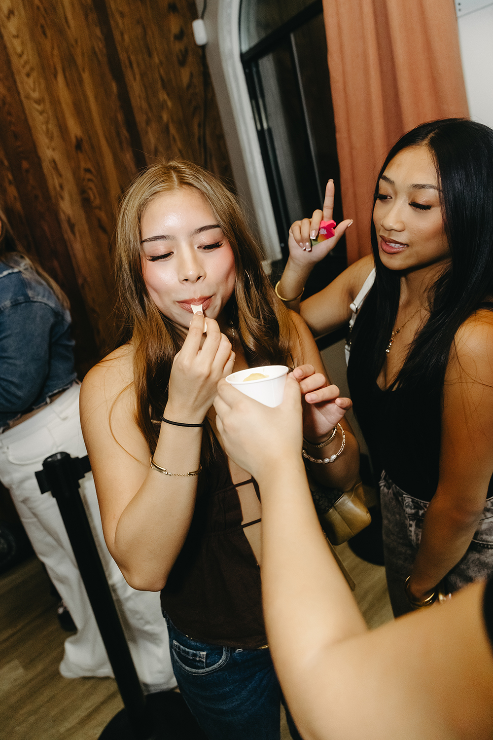 Friends sharing a scoop of mango sorbet on a late friday and saturday night.